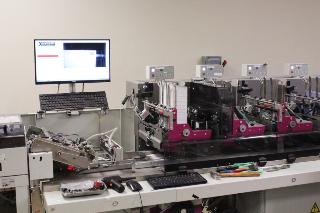 DMP BPO facility printing, folding, inserting envelope machine.